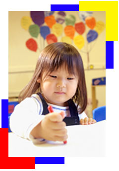 Little girl drawing with a crayon