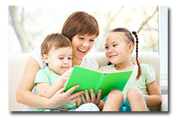 Happy mom with children reading a book